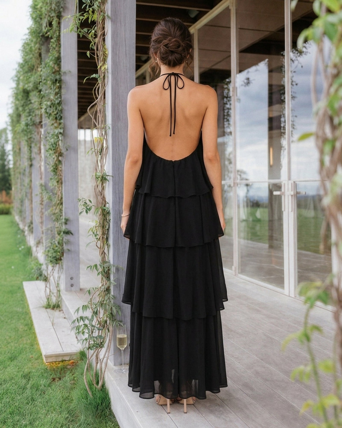 Back view of black halter neck tiered chiffon bridesmaid dress with layered ruffles