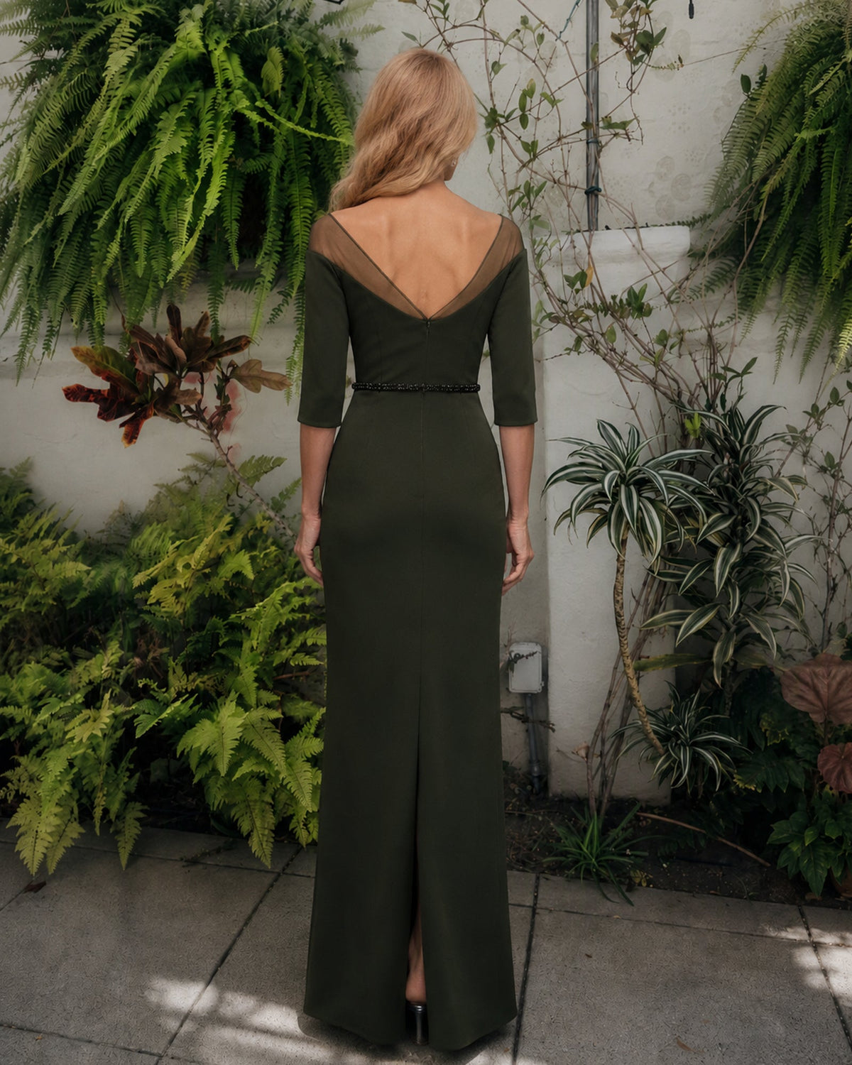 Back view of dark green off-shoulder sheath dress with three-quarter sleeves
