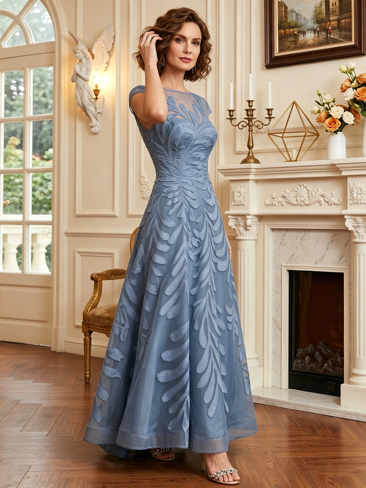 long embroidered tulle mother of the bride A-line dress with illusion neckline and cap sleeves shown in a formal wedding guest setting
