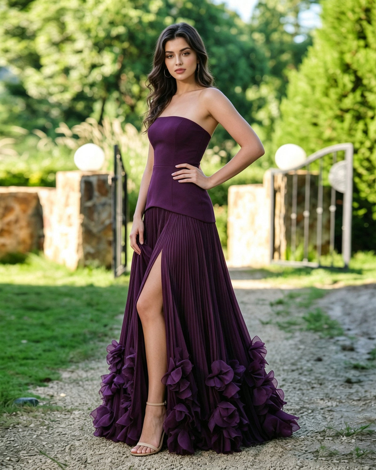 Purple strapless formal dress with pleated skirt, front slit, and floral ruffle hem