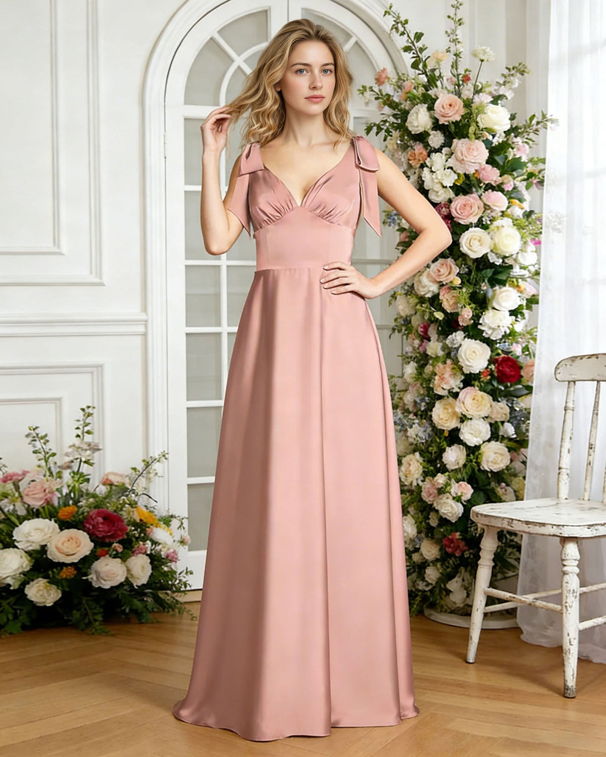 Blush satin V-neck bridesmaid dress with bow shoulder straps and empire waist, front view