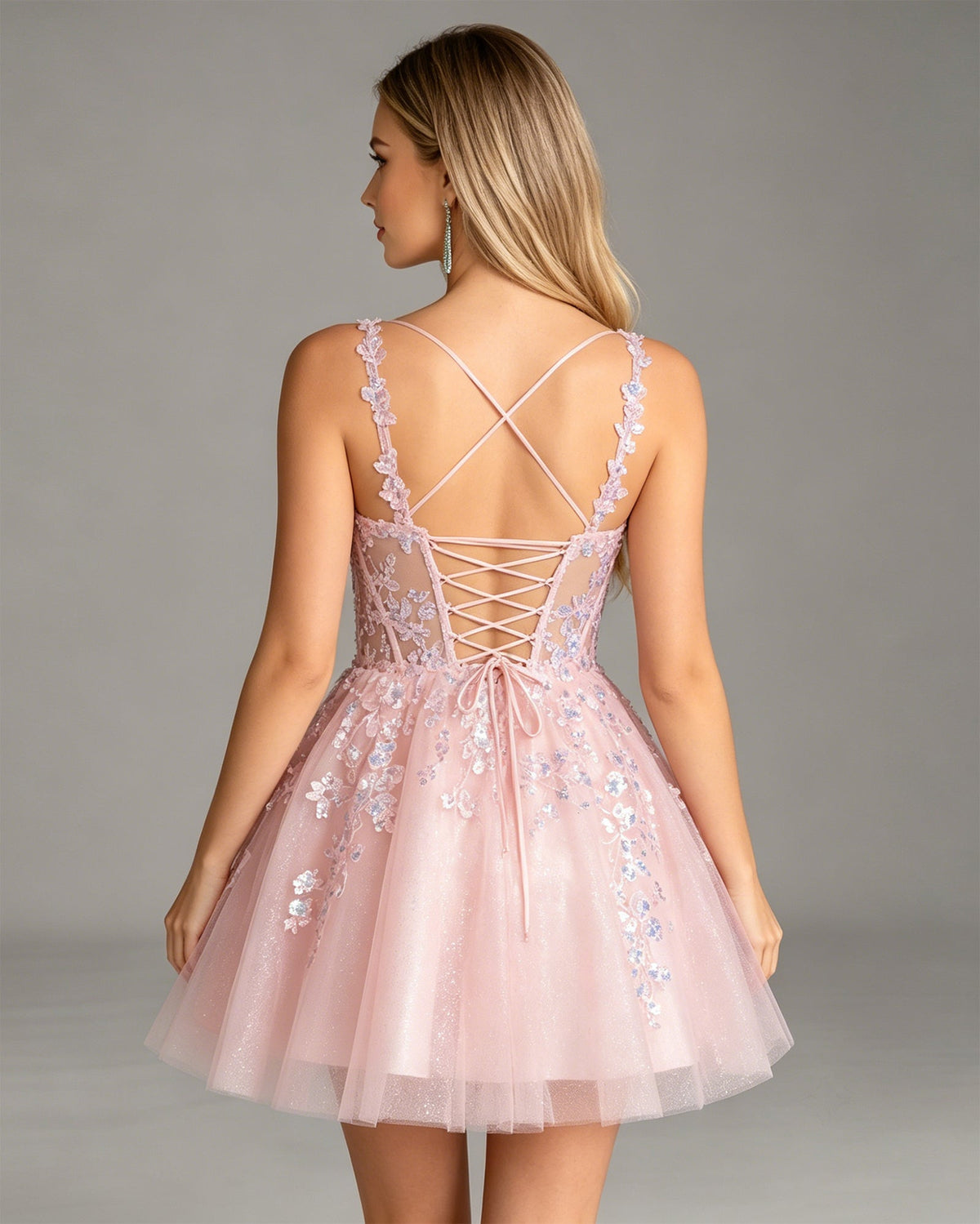 Pink tulle corset homecoming dress back with crisscross lace-up straps and applique