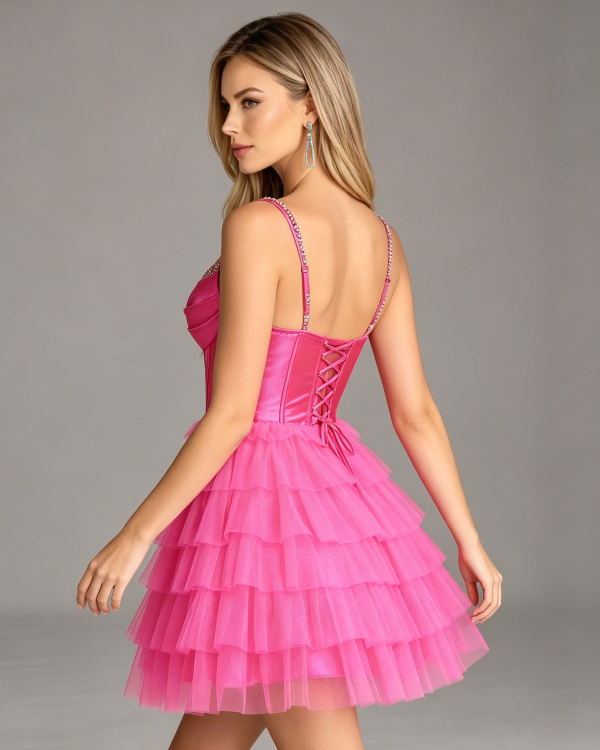 Pink beaded corset homecoming dress with open back straps and tiered tulle skirt