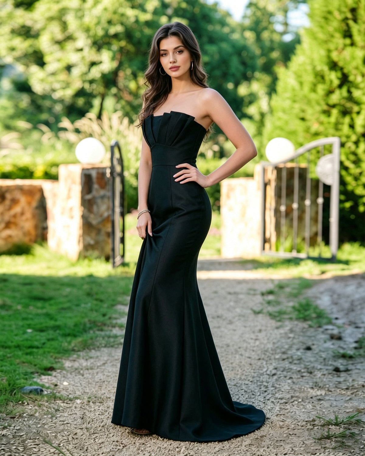 Black strapless mermaid formal dress with pleated bodice and sweeping flared skirt