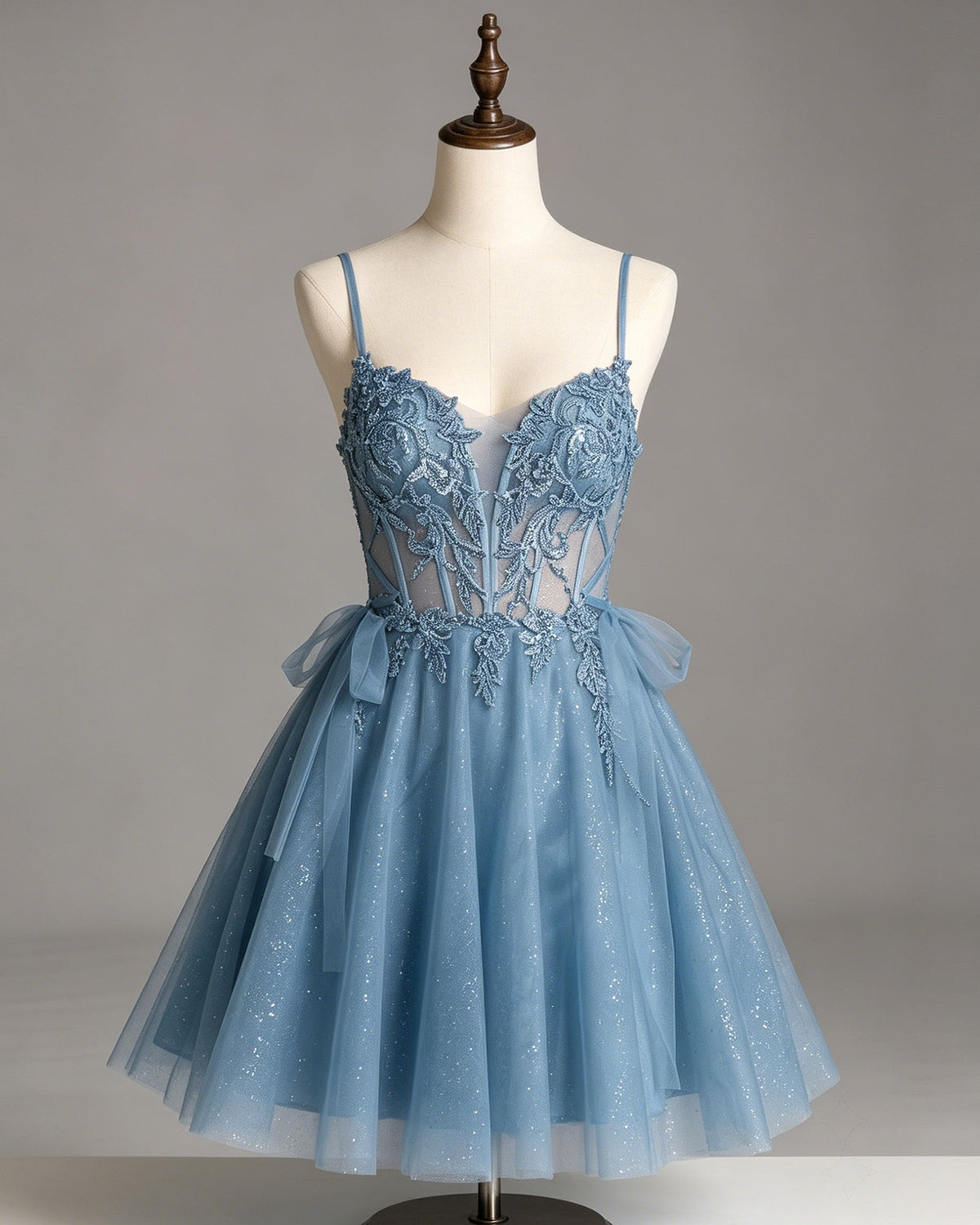 Light blue glitter tulle dress on mannequin with lace corset bodice and bow-tie waist