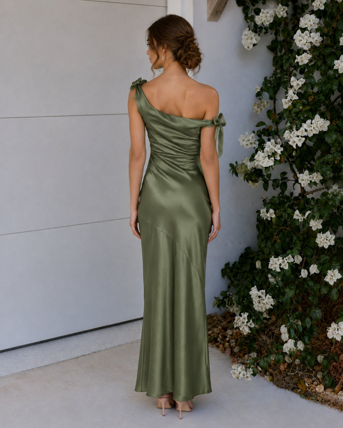 Back view: sage green satin one-shoulder mermaid dress with bow strap ties