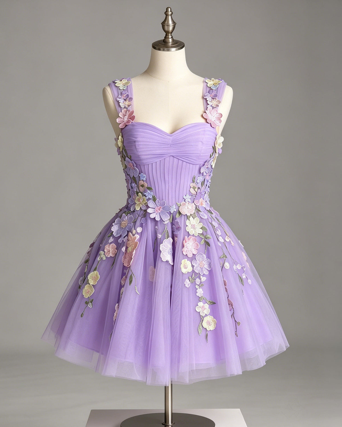 Lavender tulle A-line dress on mannequin with sweetheart bodice and floral embroidered appliques