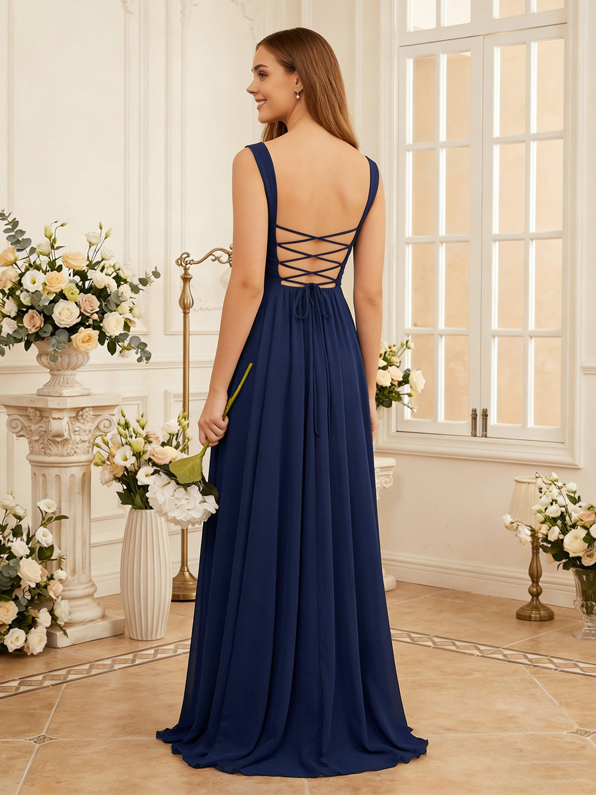 Navy chiffon bridesmaid dress with crisscross open-back straps and pleated skirt