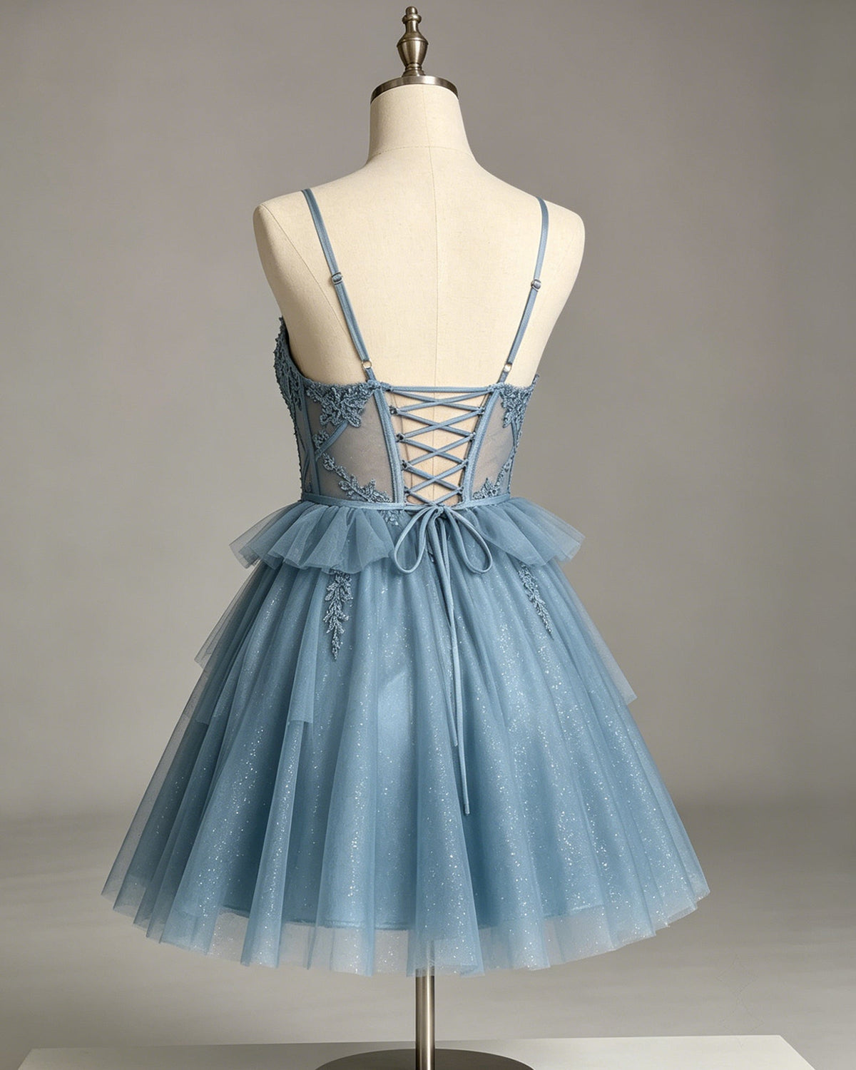 Light blue glitter tulle homecoming dress on mannequin, crisscross open-back lace bodice