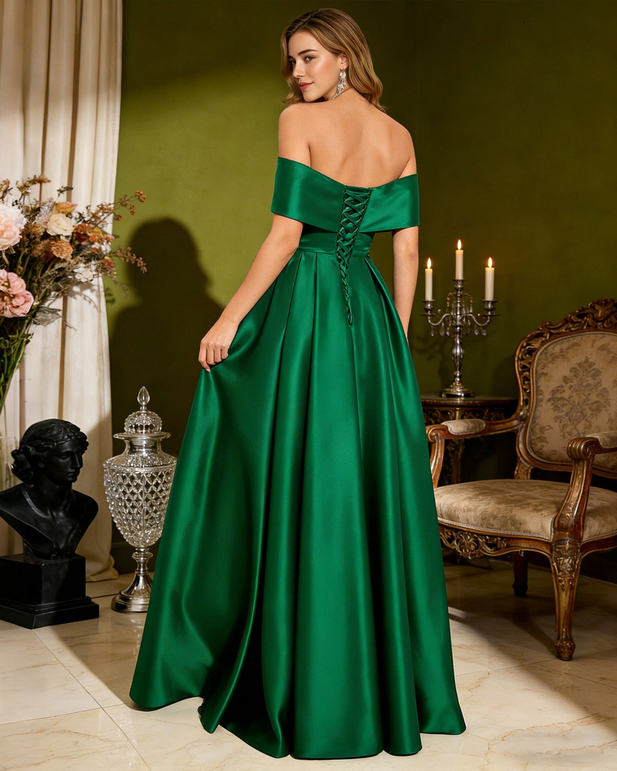 Green satin strapless prom dress with bow detail, pleated bodice, and front slit