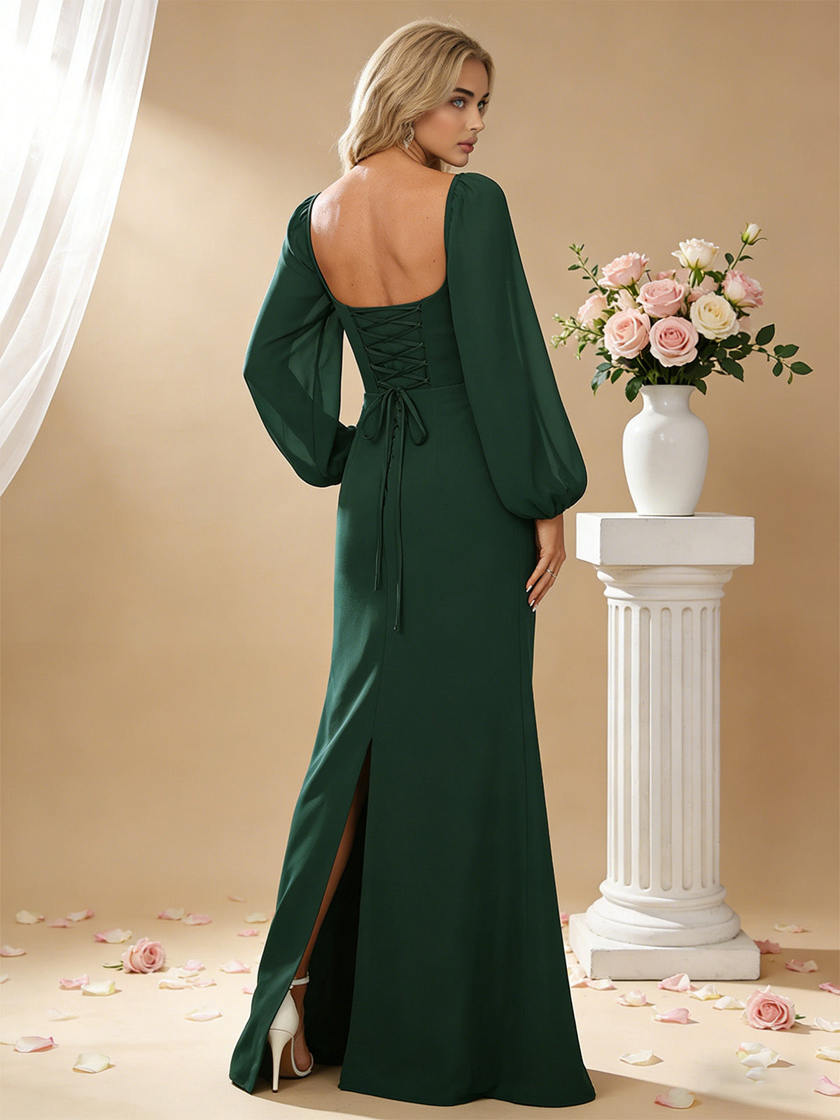 Back view of square-neck satin bridesmaid dress in dark green with long puff sleeves and slit.