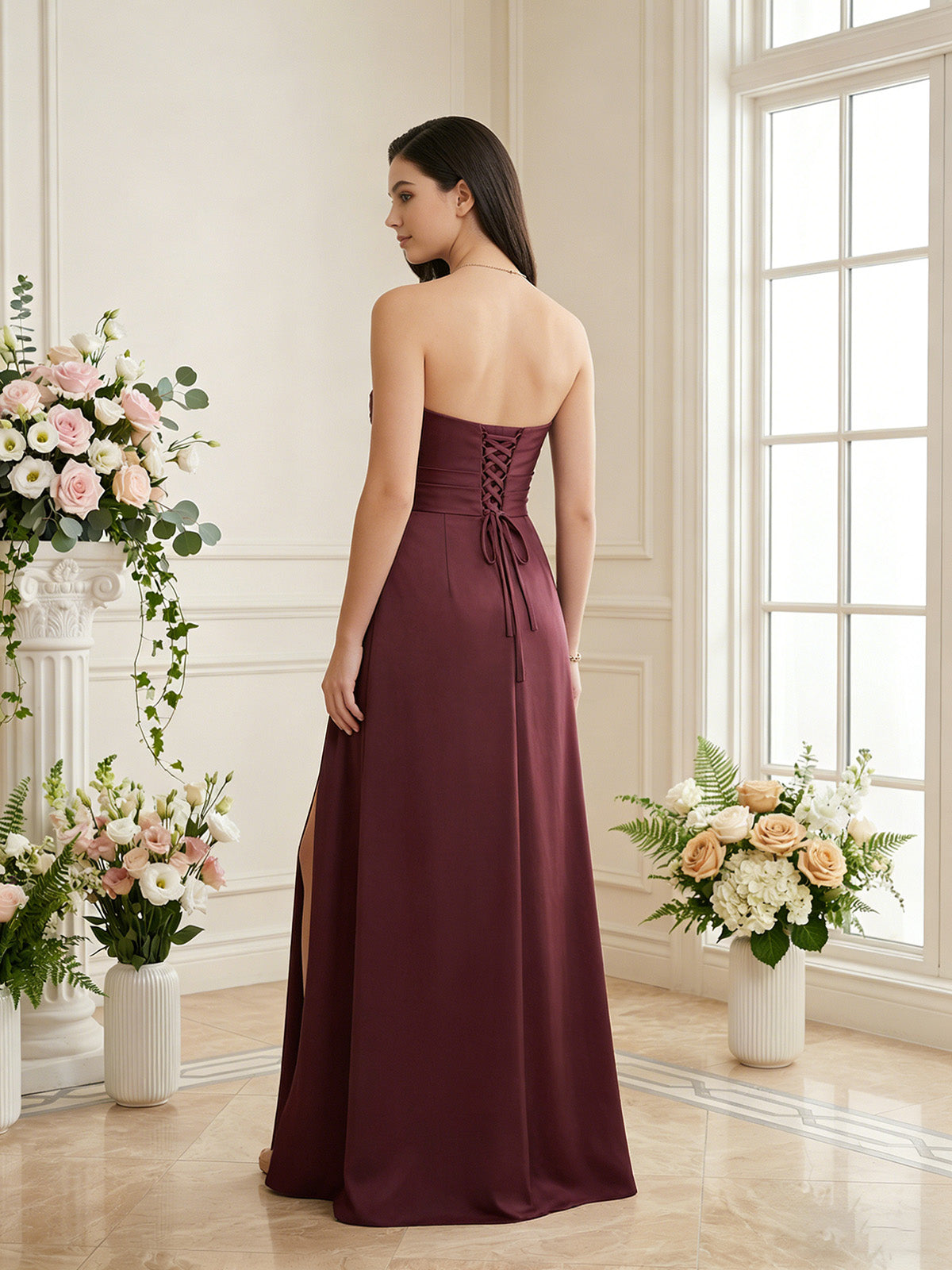 Back view of strapless pleated satin bridesmaid dress in wine red with side slit