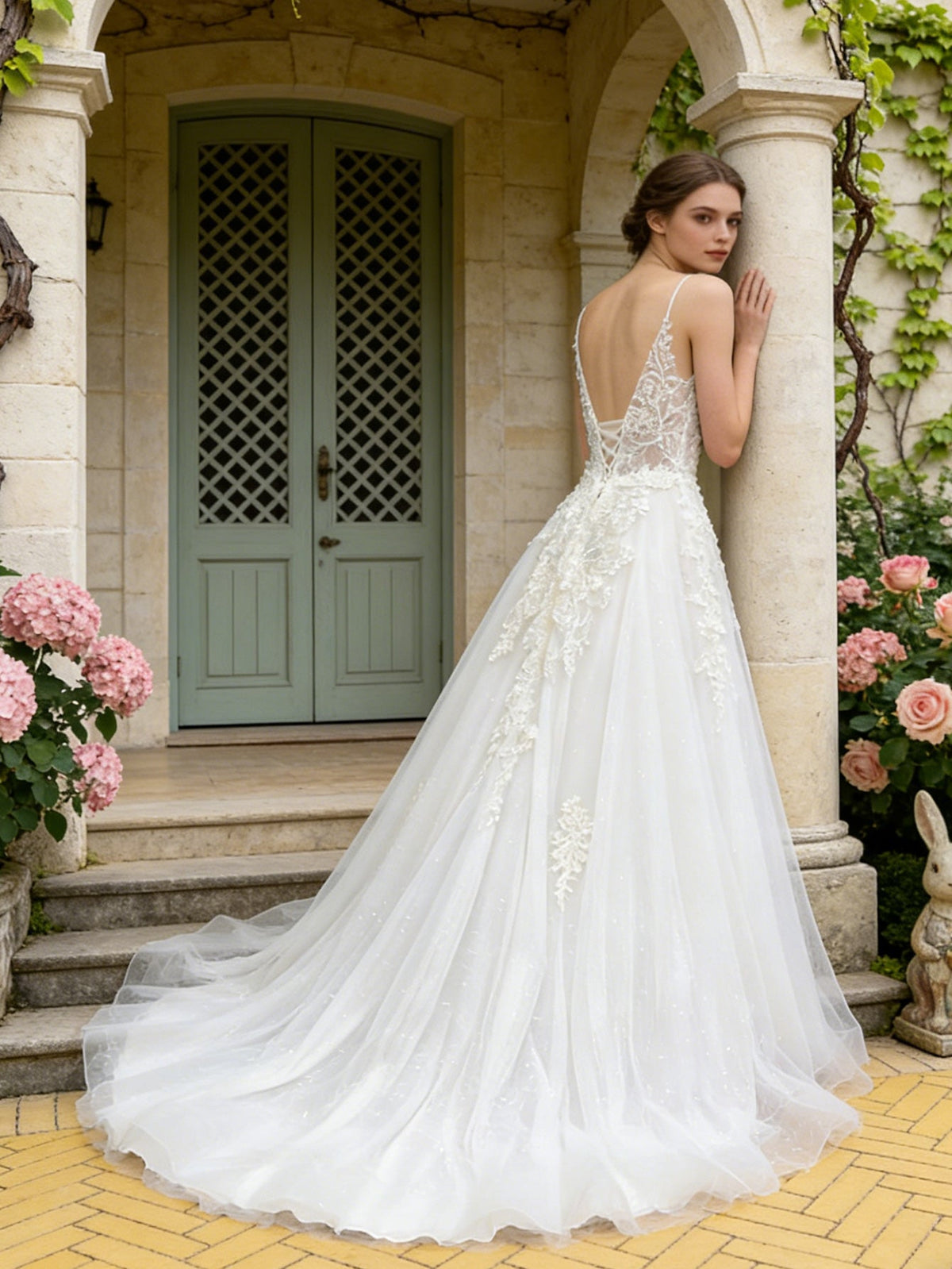 White lace wedding ball gown with spaghetti straps and flowing tulle skirt, back view
