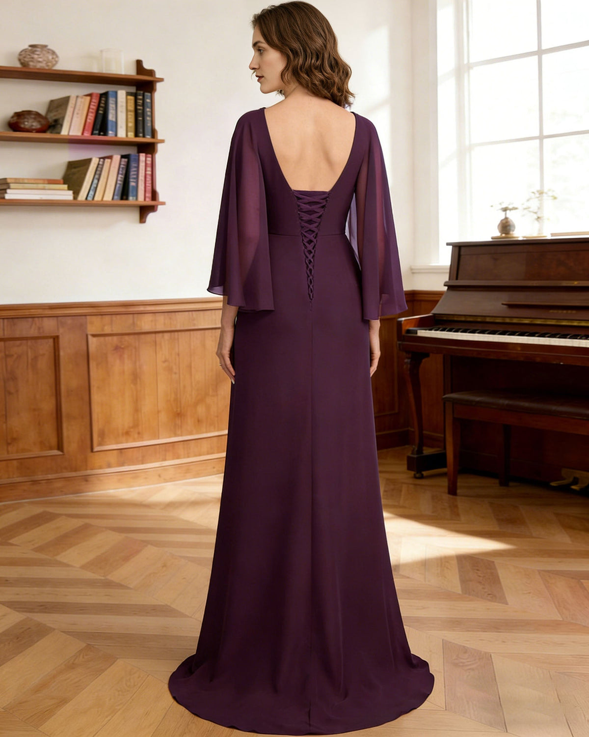Back view of purple long formal gown with capelet sleeves and beaded back neckline detail.