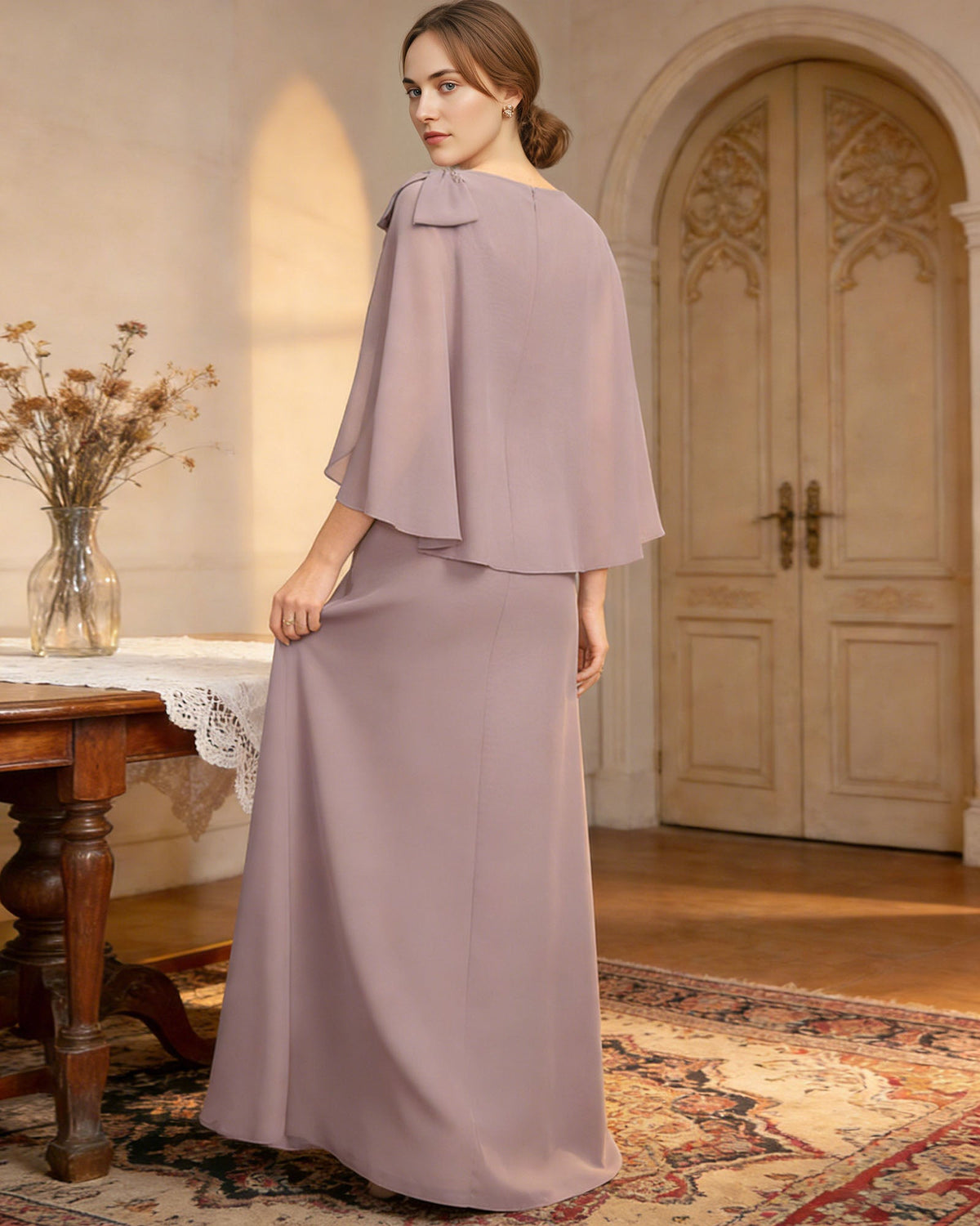 long cape sleeve mother of the bride dress with jewel neckline, bow shoulder, and chiffon column skirt back or side view for mother of the bride occasion styling