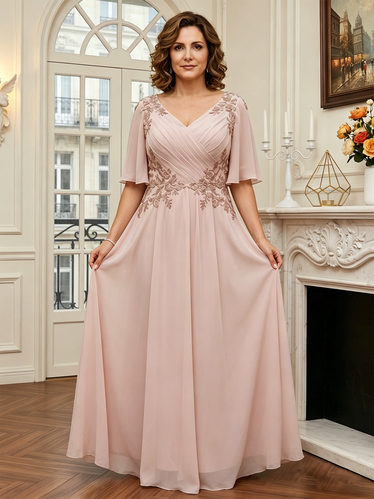 Blush pink long A-line chiffon dress with lace detailing at neckline and flutter sleeves