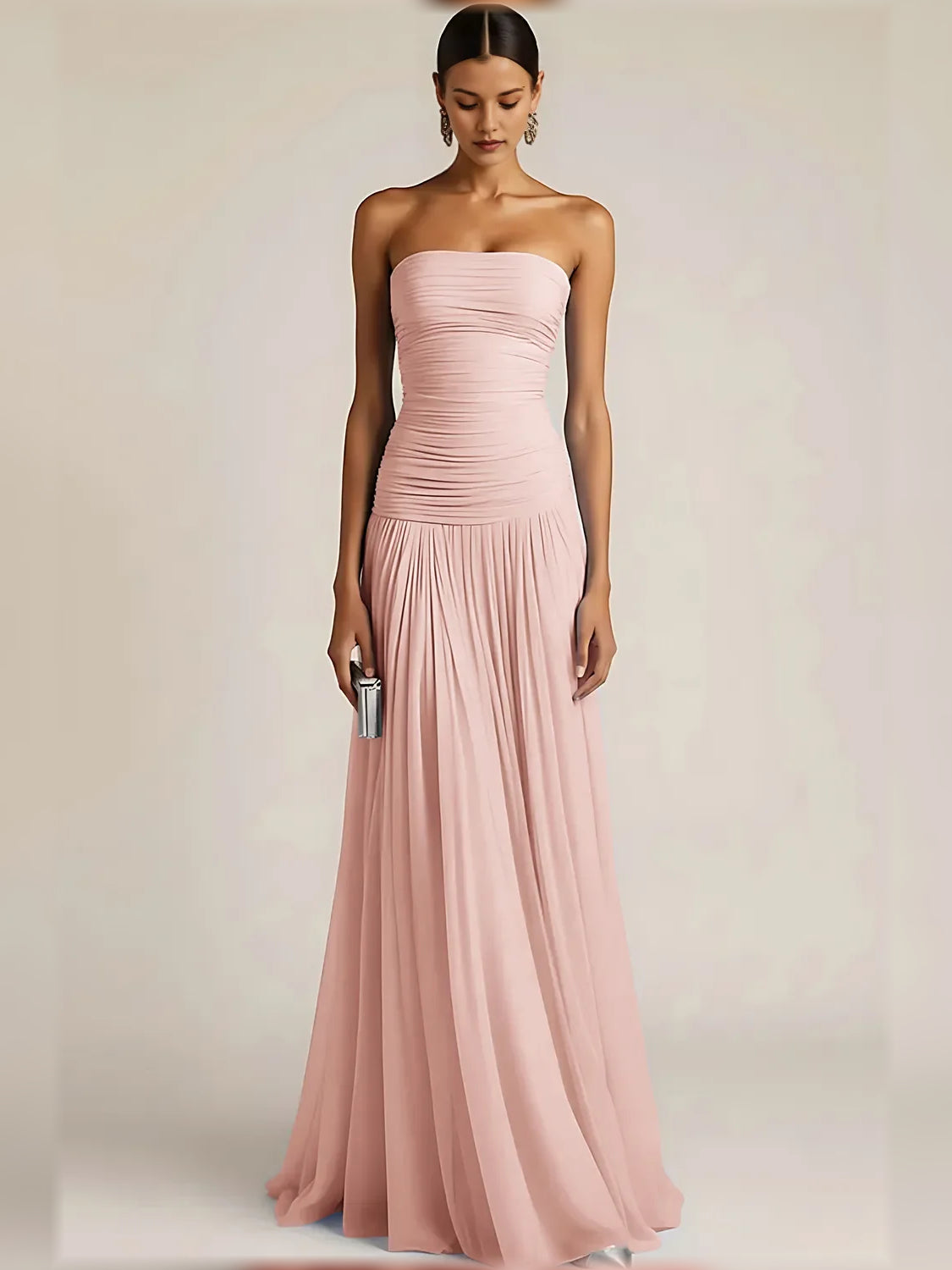 Light pink strapless formal dress with ruched bodice and pleated floor-length skirt