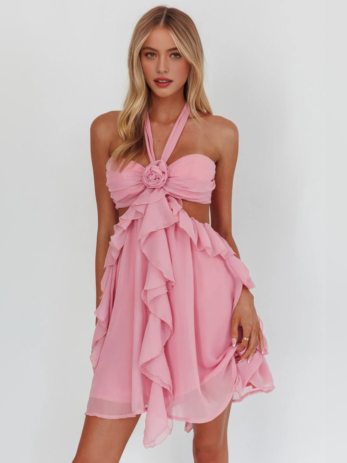 Pink chiffon homecoming dress with halter cut-out bow and flowing layered ruffle hem