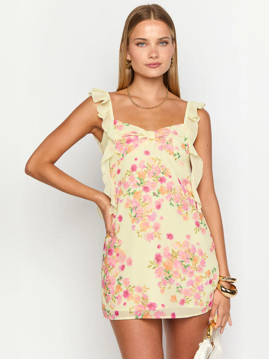 Front view of yellow floral mini dress with ruffled cap sleeves and sweetheart-style bow