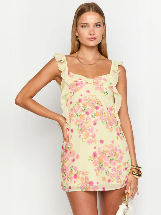 Front view of yellow floral mini dress with ruffled cap sleeves and sweetheart-style bow