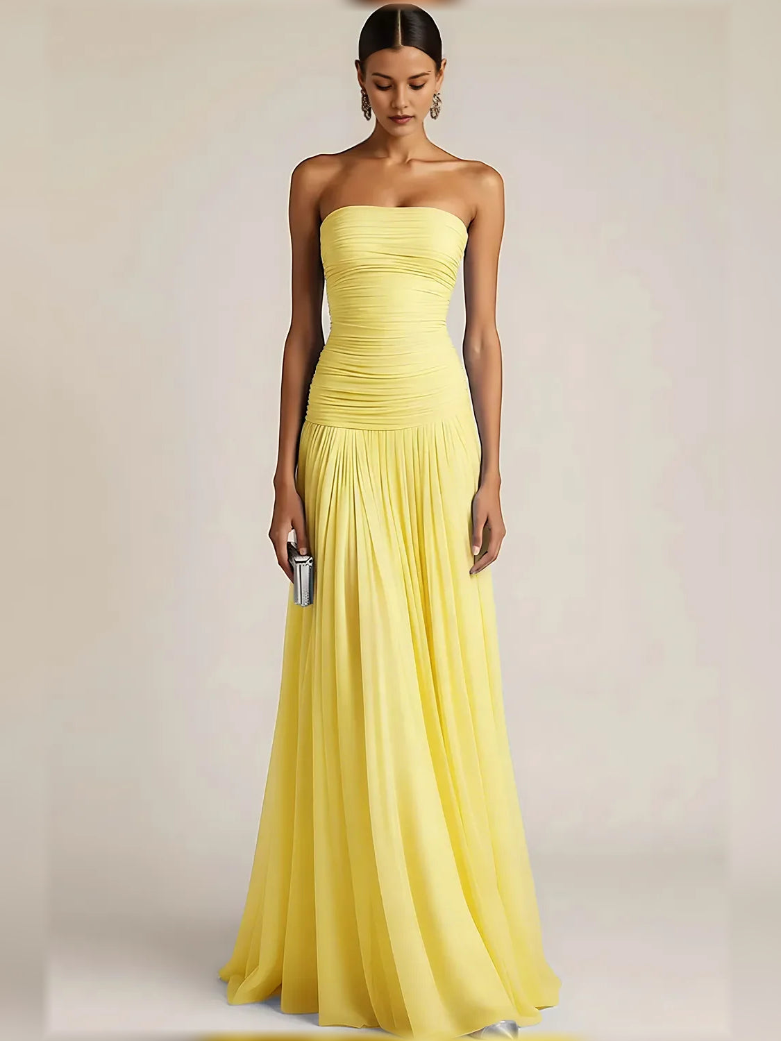 Yellow strapless formal dress with ruched bodice and pleated floor-length skirt