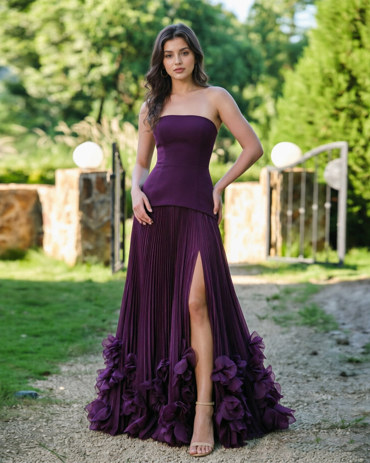 Purple strapless formal dress with pleated front slit and layered floral ruffle hem