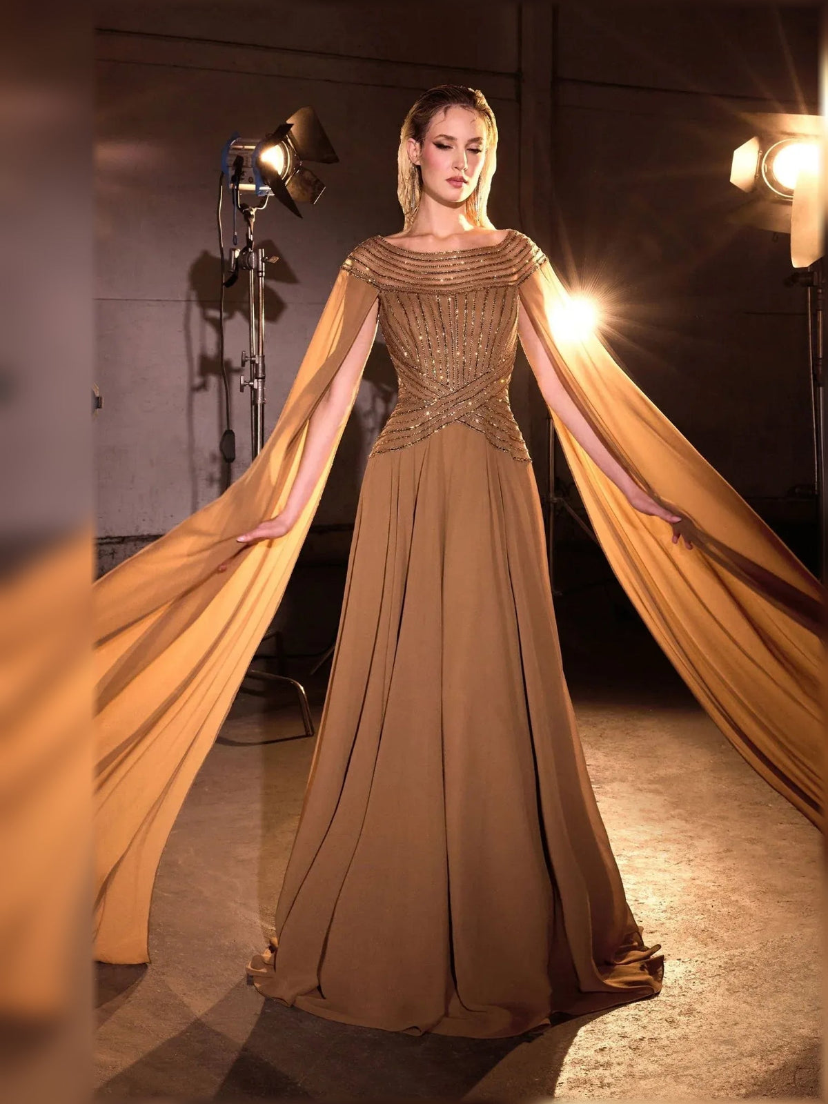 Bronze chiffon mother-of-the-bride gown with beaded off-shoulder top and long flowing cape