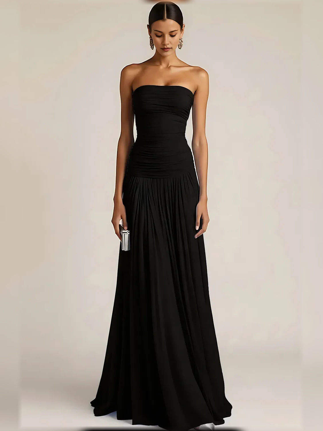 Black strapless formal dress with ruched bodice and pleated floor-length skirt