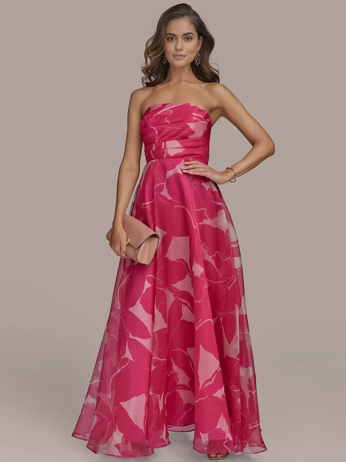 Front view of fuchsia strapless formal dress with abstract white print and gathered skirt