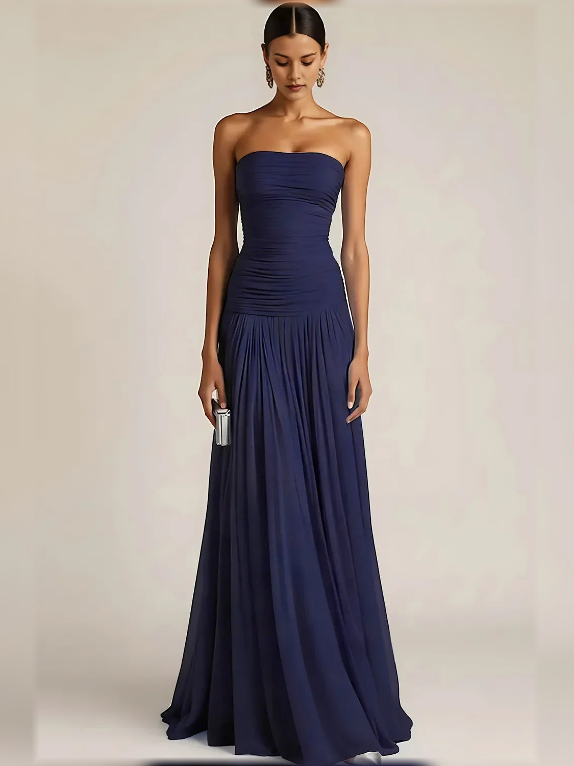 Navy blue strapless formal dress with ruched bodice and pleated floor-length skirt