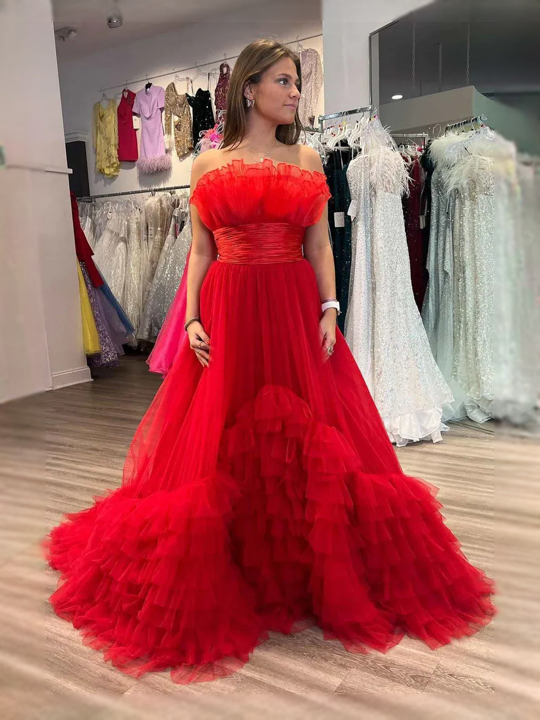 Red strapless sweetheart A-line tulle prom dress with ruched bodice and ruffled tiered skirt