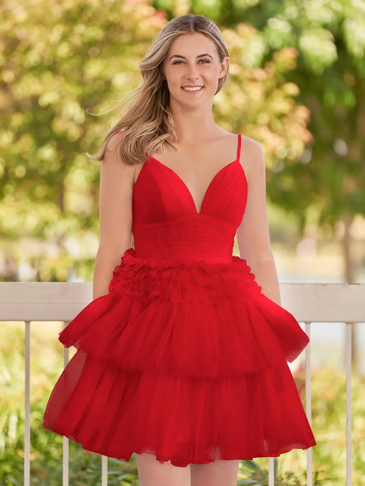 Red tulle mini dress with V-neck, spaghetti straps, and layered ruffle skirt.