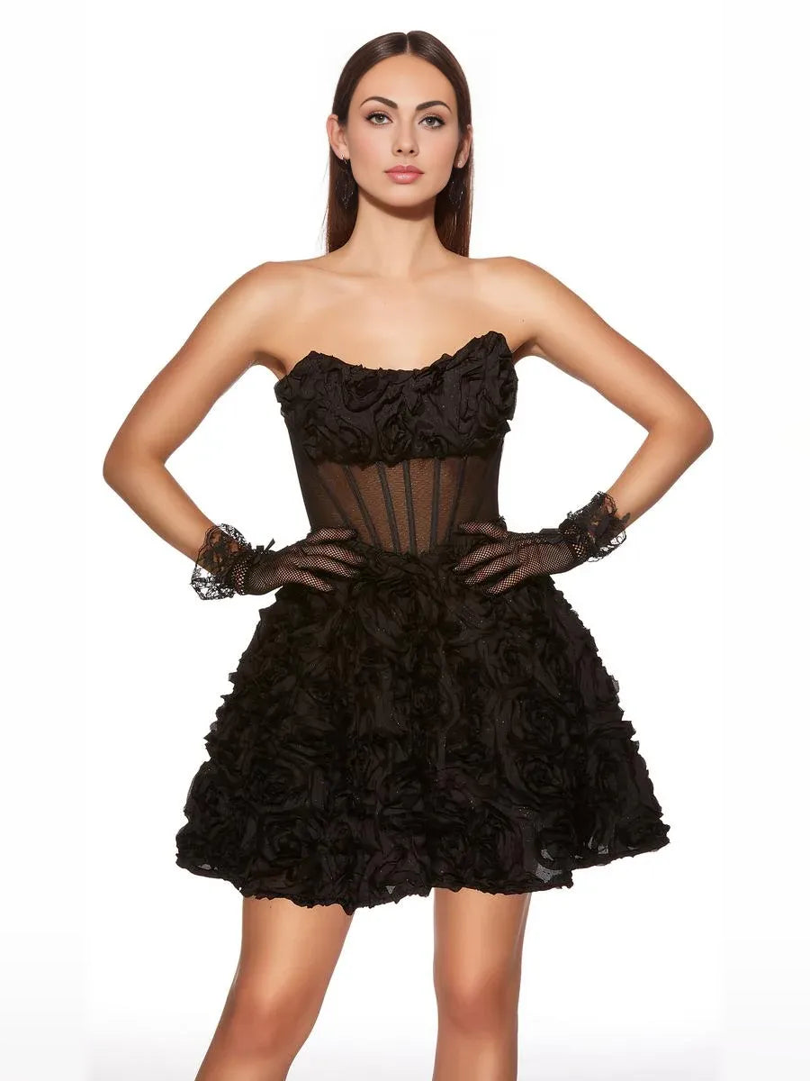 Black strapless mini dress with corset bodice, sheer panel, and layered floral rosettes