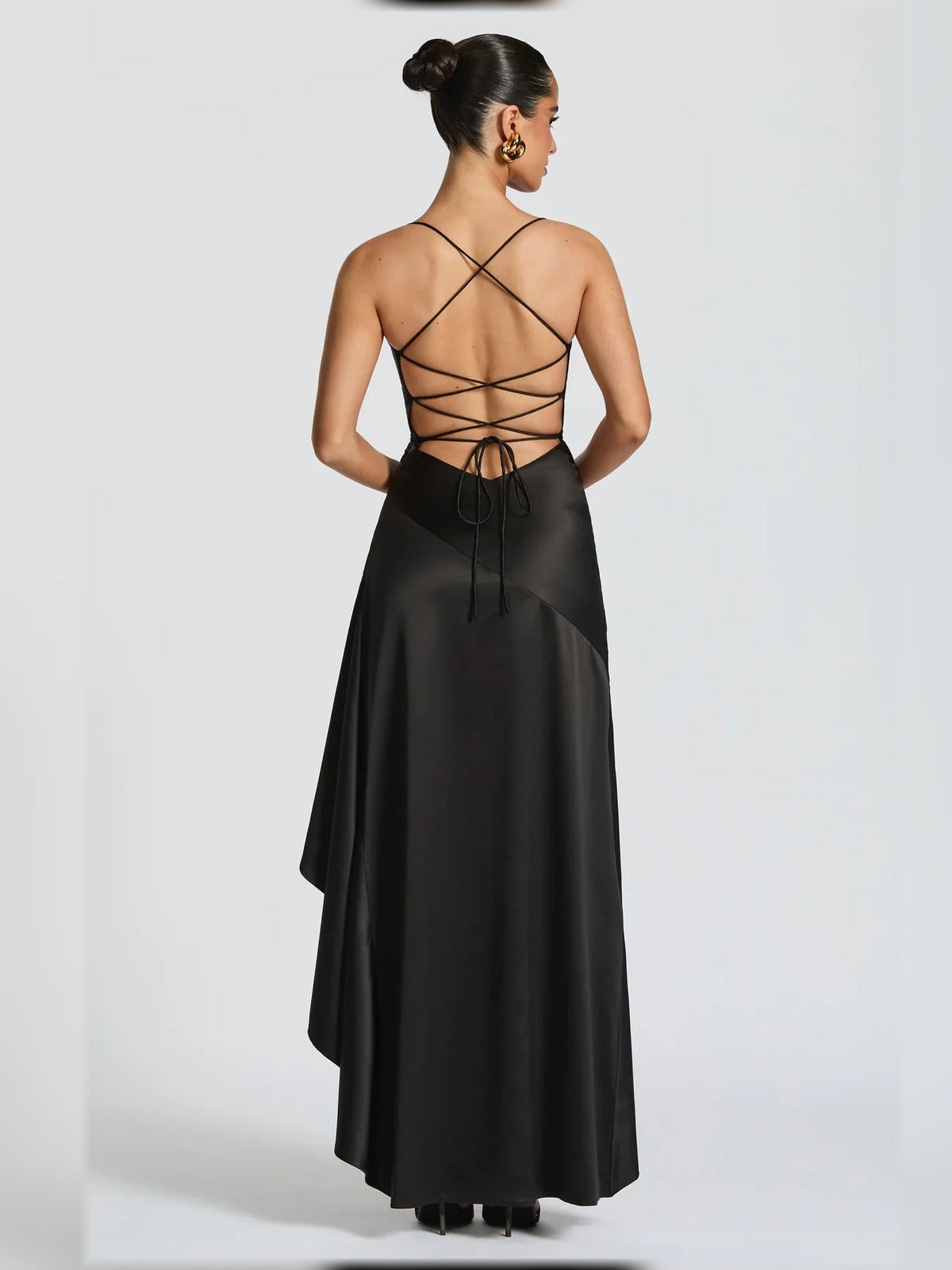 Black formal sheath dress with open back crisscross straps and long draped skirt hem