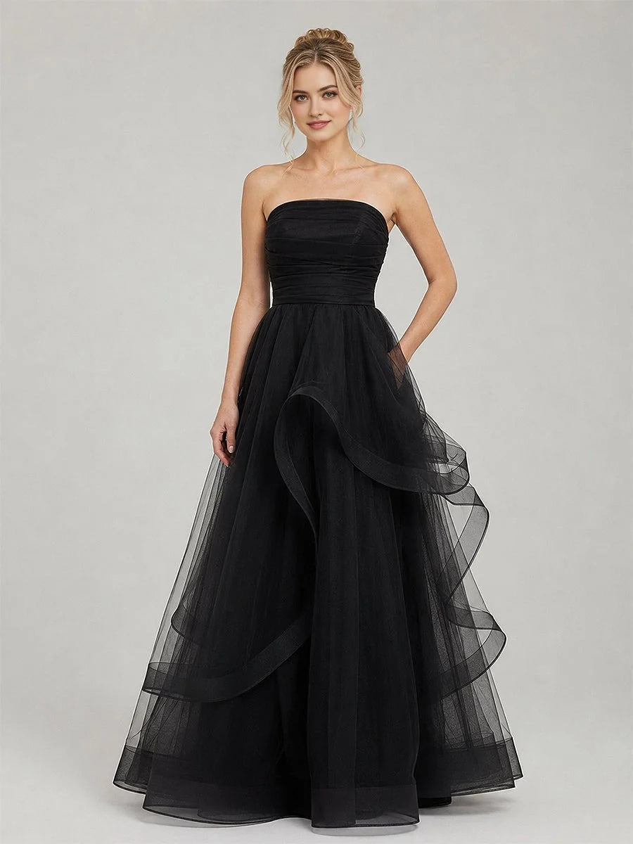 Black strapless tulle ball gown with ruched corset bodice and layered ruffle skirt