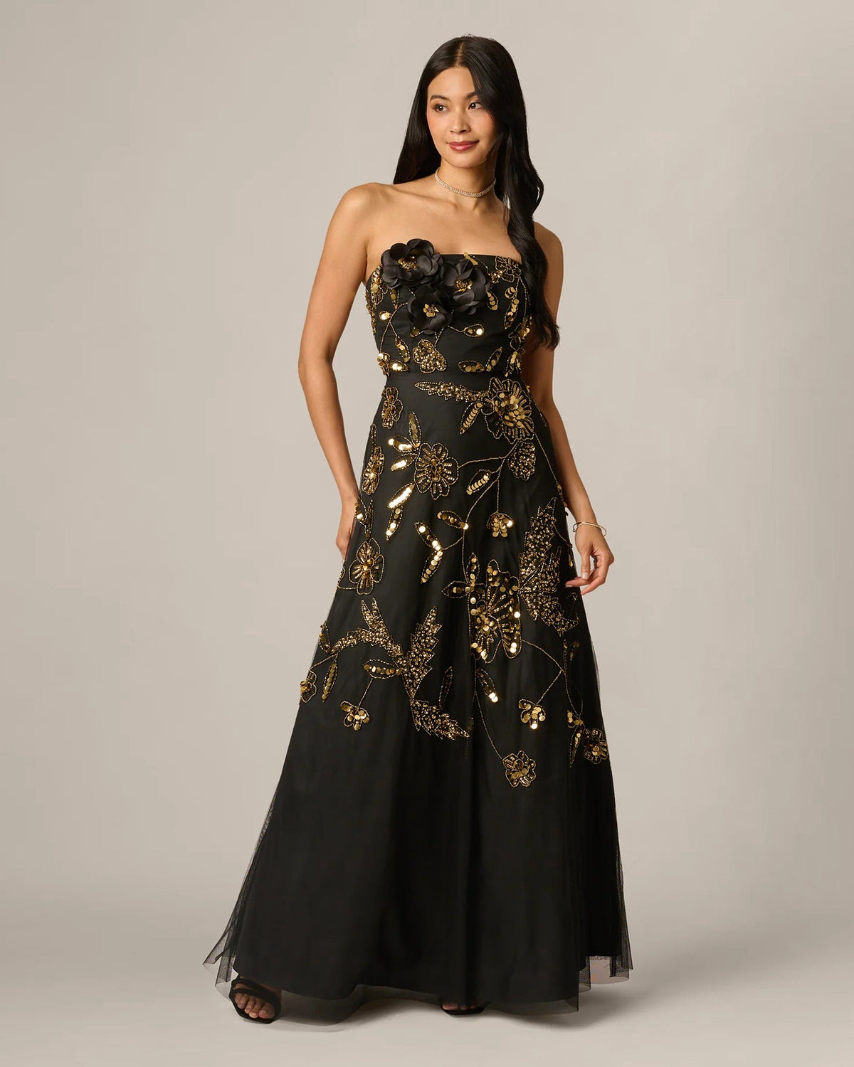 Black strapless A-line maxi dress with gold floral embroidery and beaded clusters