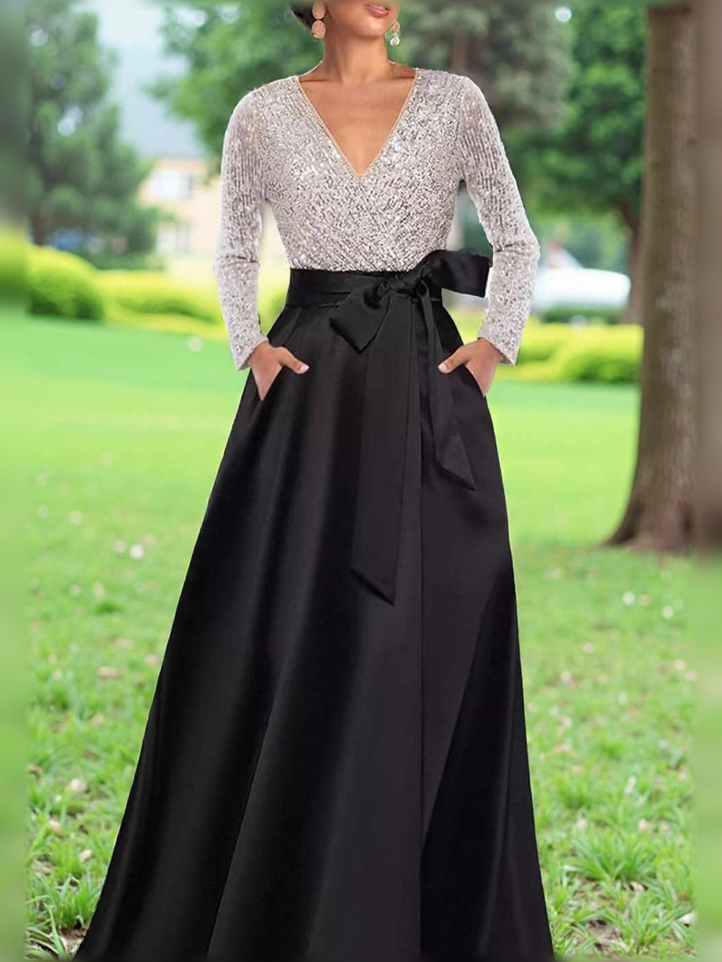 Black A-line formal dress with V-neck sequin bodice, long sleeves, satin skirt, waist bow.