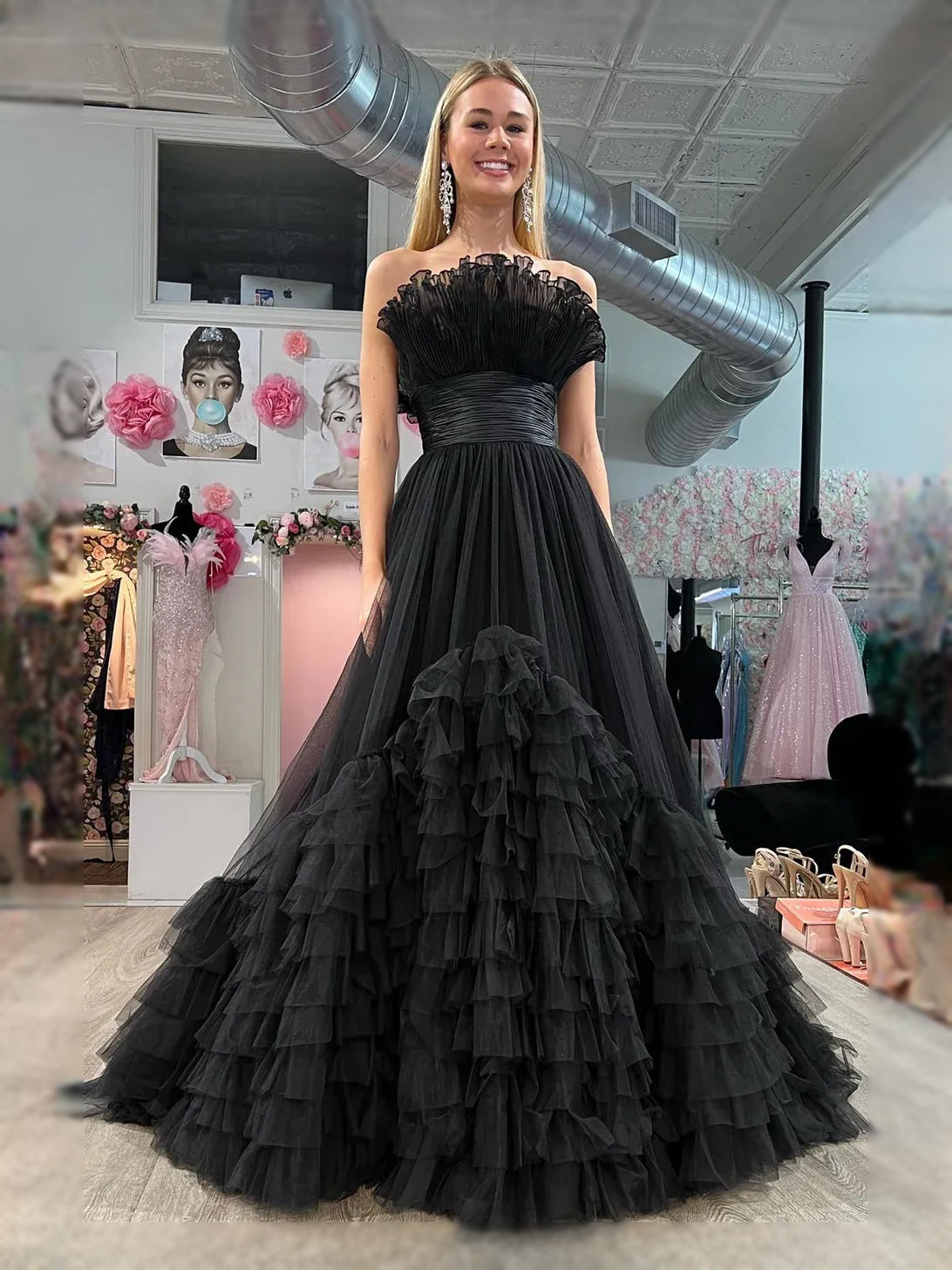 Black strapless sweetheart maxi dress with ruched bodice and tiered ruffle tulle skirt.