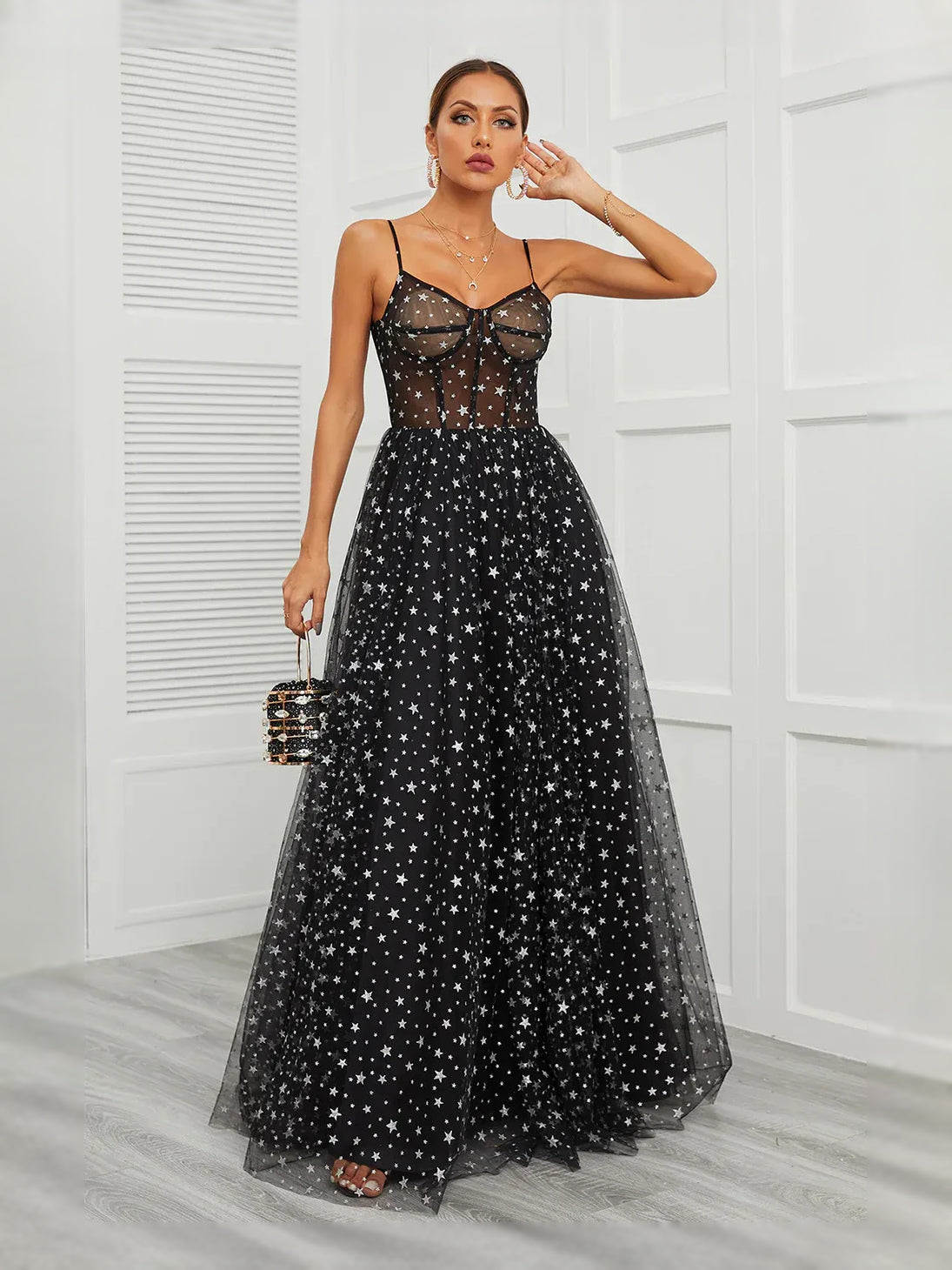 Black draped corset maxi dress with starry tulle A-line skirt, sweetheart neckline.