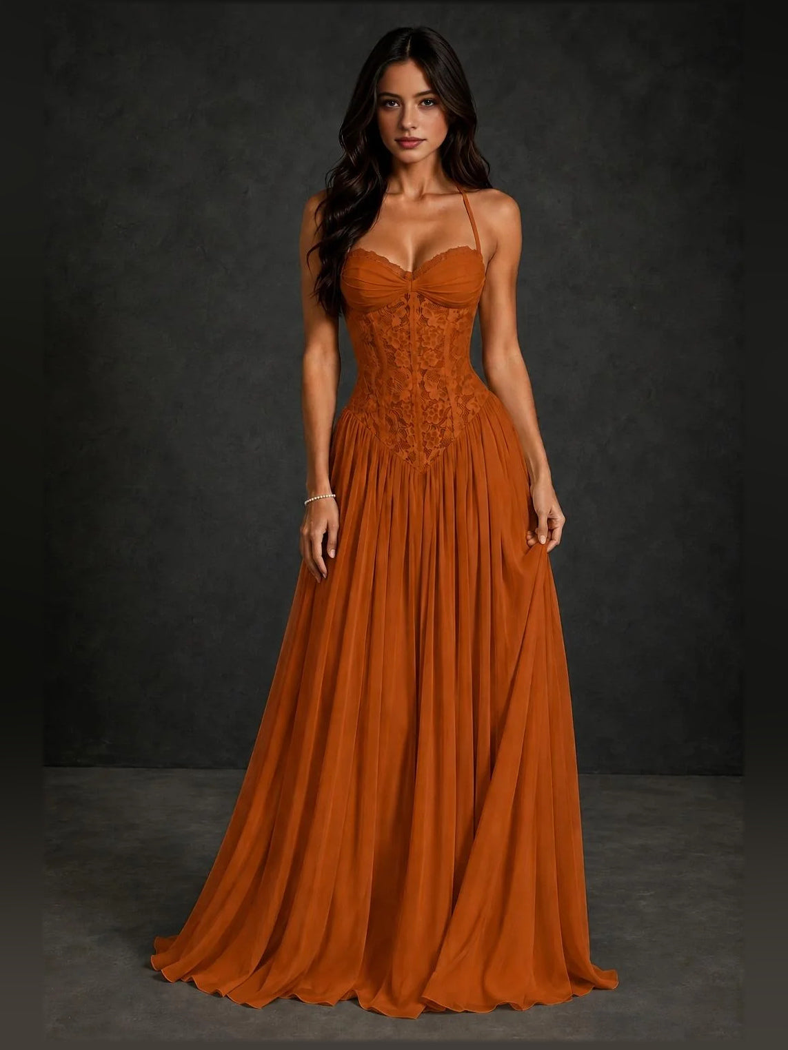 Burnt orange A-line prom dress with sweetheart neckline, spaghetti straps, pleated skirt.