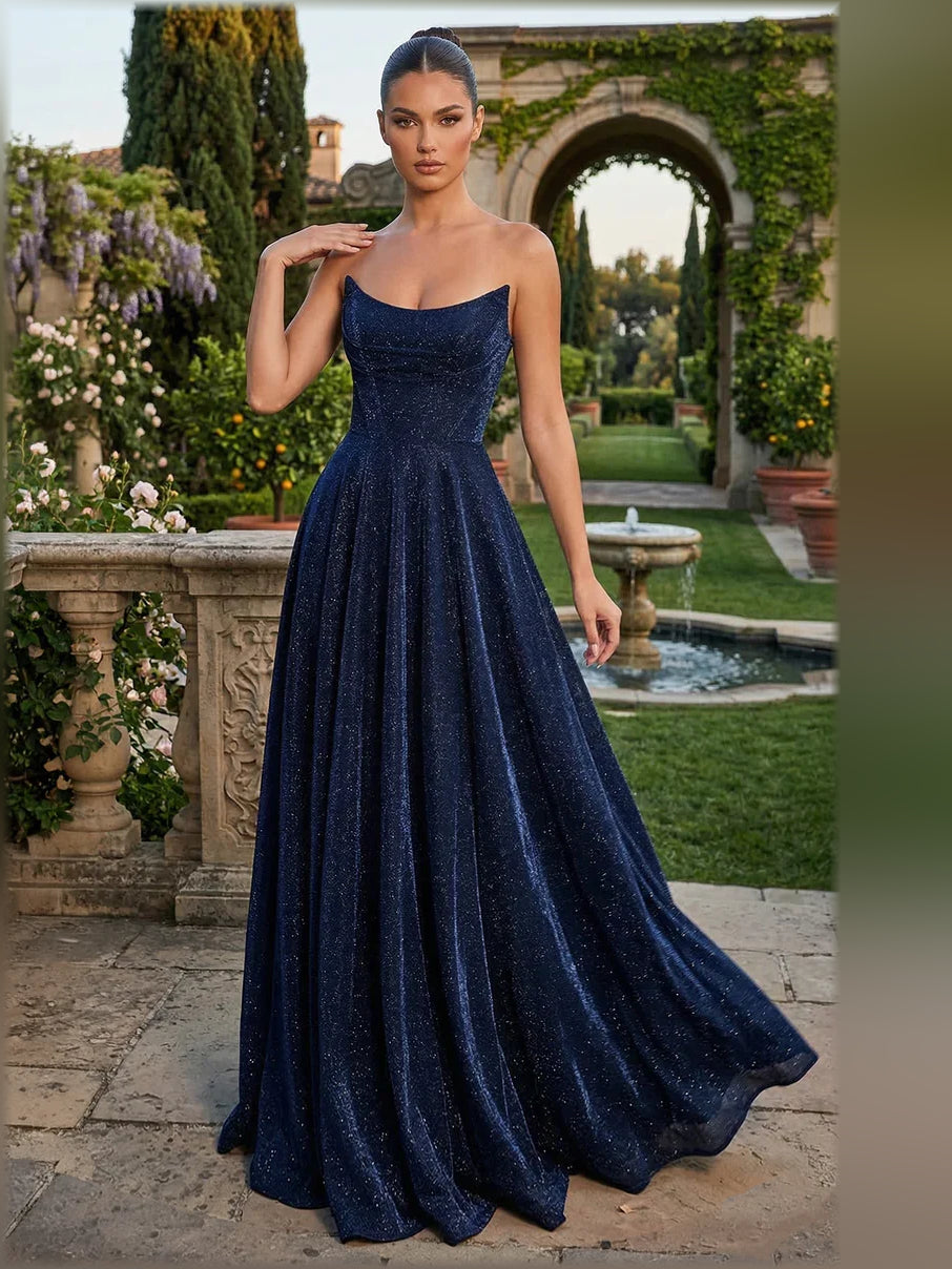Dark navy strapless formal dress with lace-up open back and flowing floor-length skirt