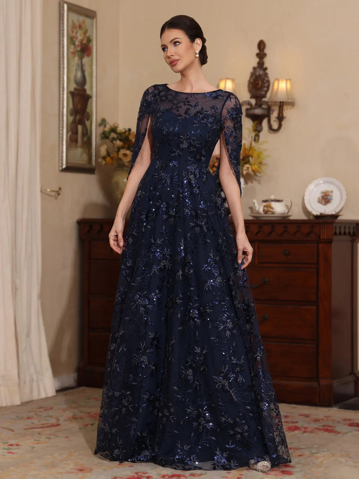 Dark navy tulle A-line gown with illusion neckline and scattered floral embroidery, floor length