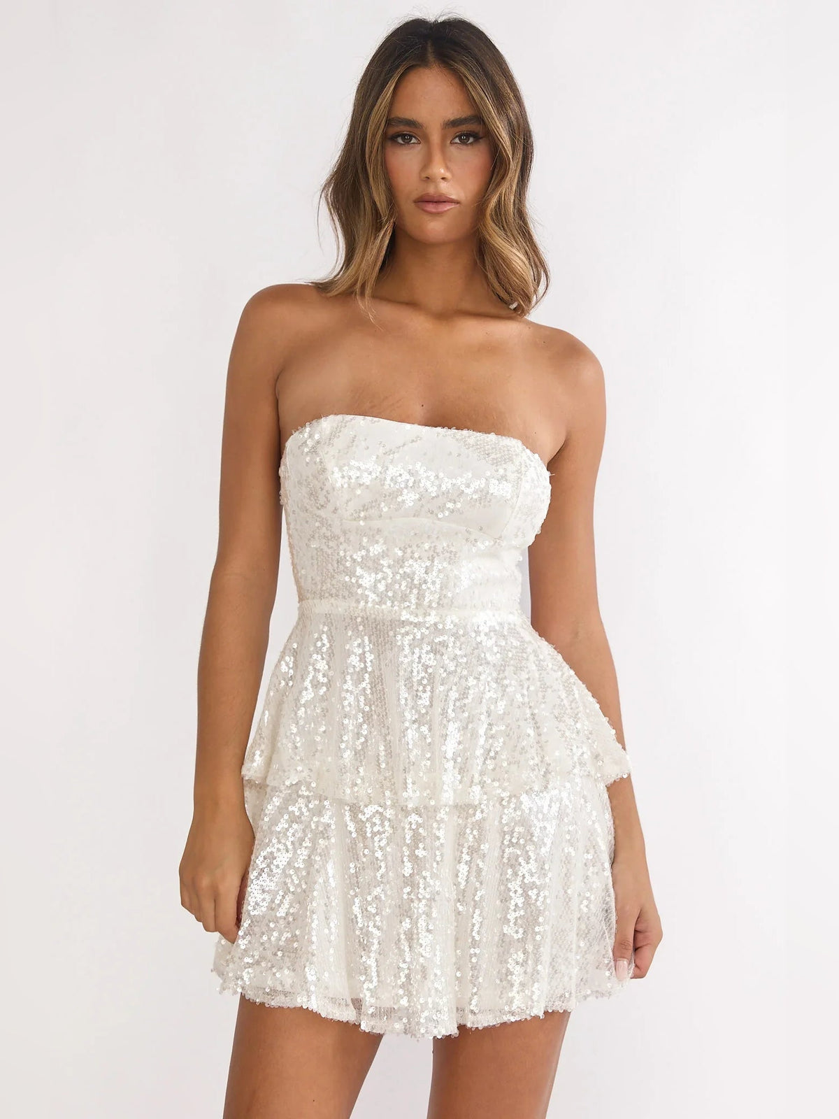 Ivory strapless sequin mini dress with tiered ruffle skirt and flared silhouette