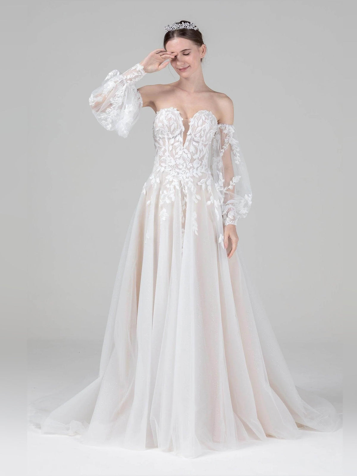 Ivory lace A-line wedding dress with off-shoulder sleeves and layered tulle skirt, front