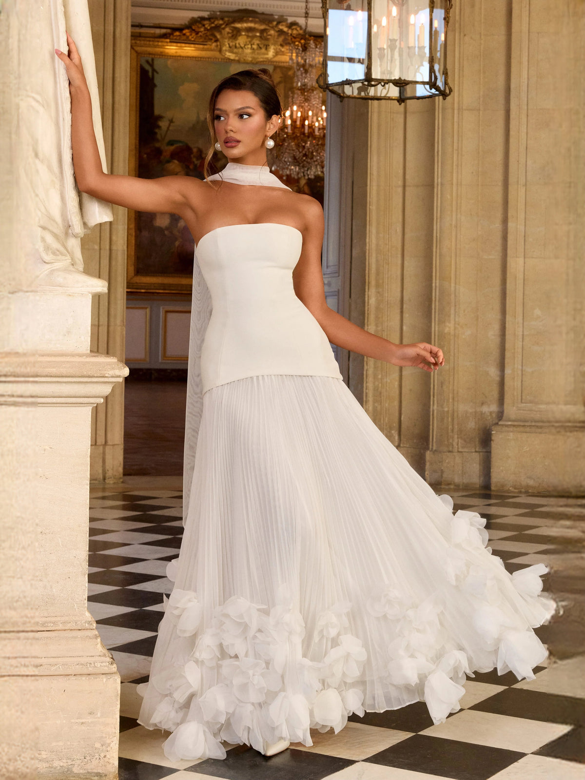 Ivory strapless corset bodice wedding dress with pleated ruffle skirt and layered floral accents