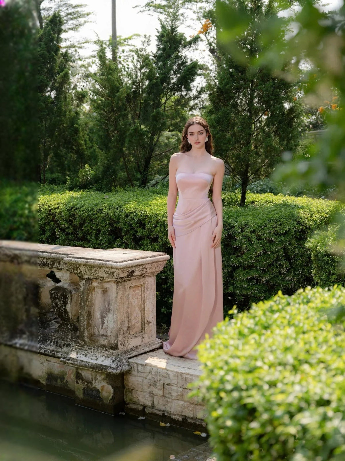 Light blush satin bridesmaid dress with thin straps, sweetheart neckline, ruched detailing, long length