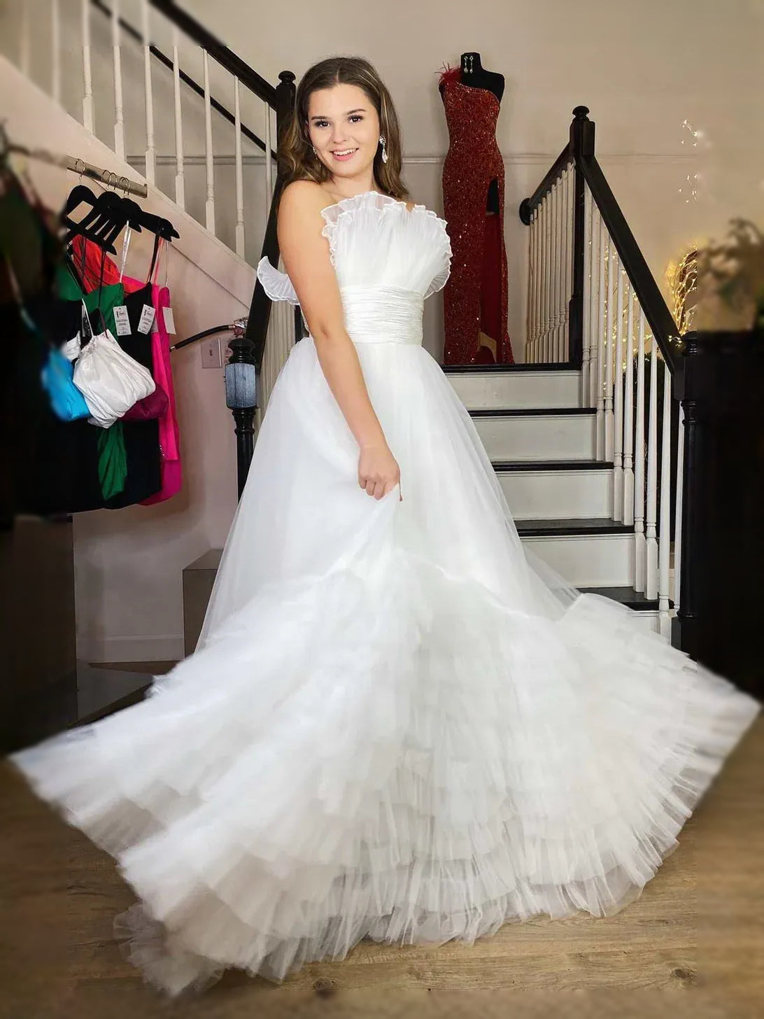 White strapless sweetheart maxi dress with ruched bodice and tiered ruffle tulle skirt.