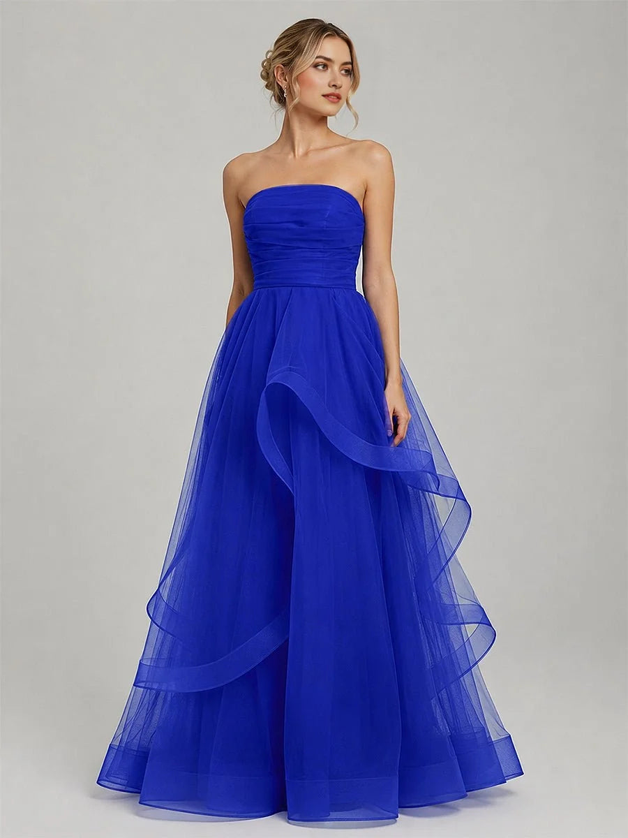 Royal blue strapless tulle ball gown with ruched corset bodice and layered ruffle skirt