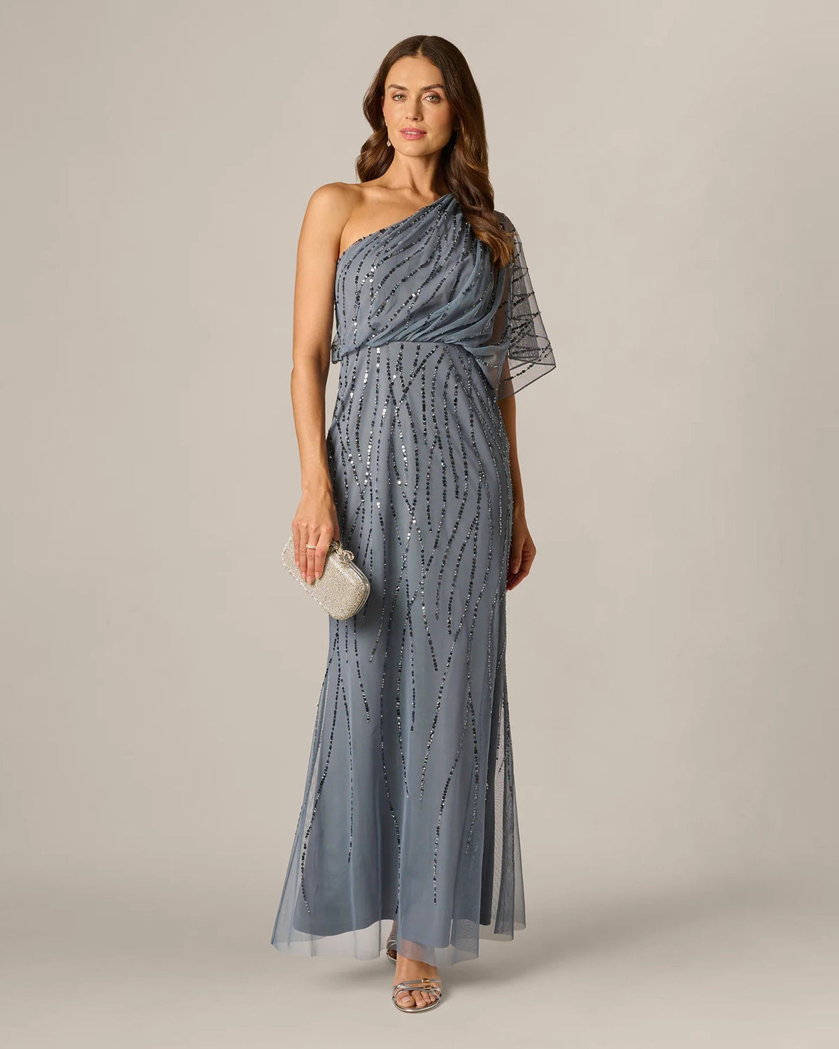 Dusty blue one-shoulder draped A-line maxi dress with sequins and sheer sleeve overlay