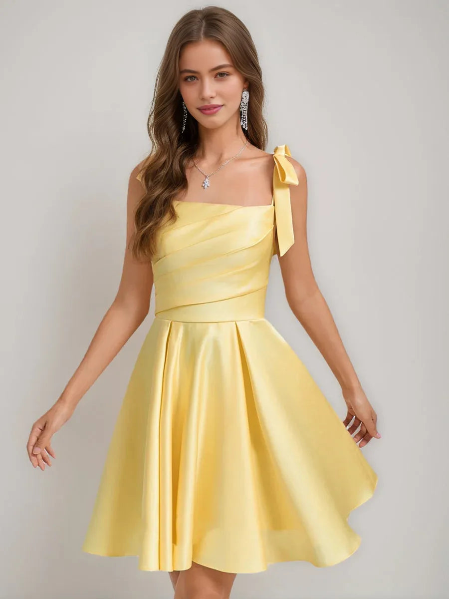 Yellow satin square-neck A-line short dress with bow shoulder straps and flared skirt.
